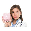 <p>Health care concept. Expensive medical insurance or medical budget cuts. Unhappy doctor woman shaking piggy ba</p>