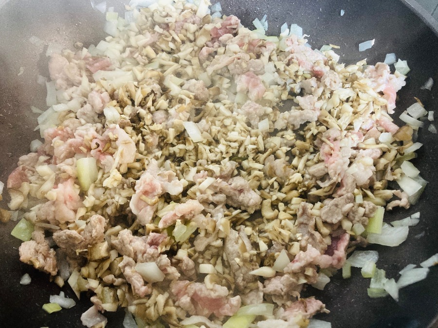 粗みじん切りにした豚こま肉・玉ねぎ・にんにくを加えて炒めていきます
