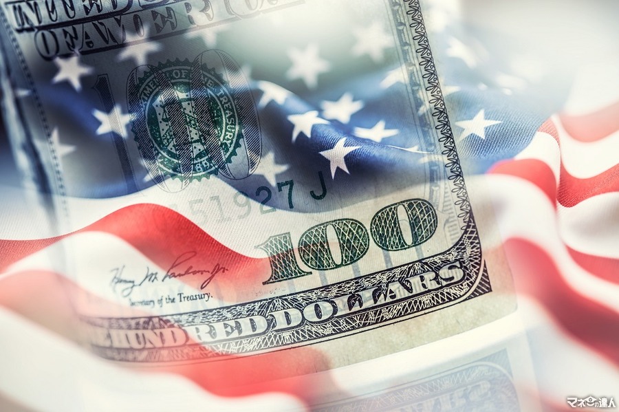 <p>USA flag and American dollars. American flag blowing in the  wind and 100 dollars banknotes in the background.</p>
