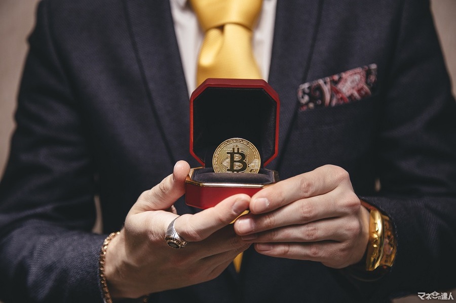 <p>a man holds an expensive ring or jewelry box with bitcoin as if he makes an offer to marry</p>
