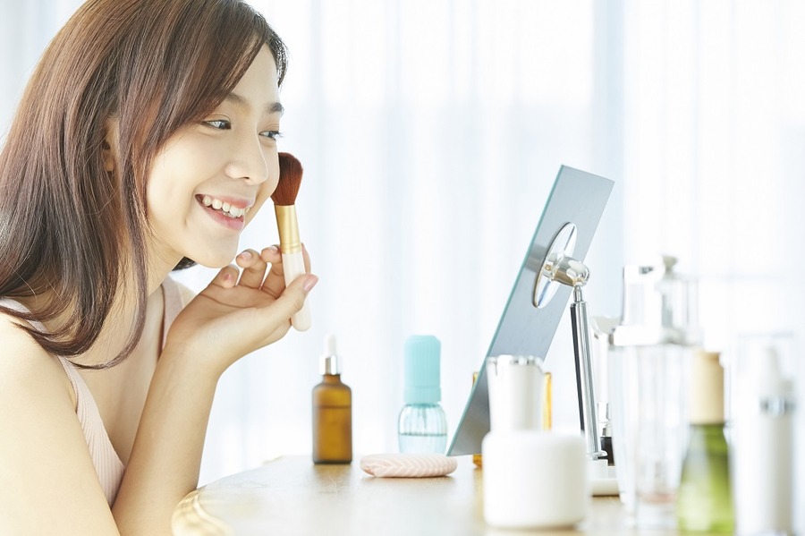 化粧をする笑顔の女性