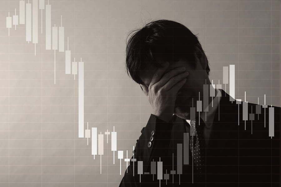 価格の下落に落ち込む男性