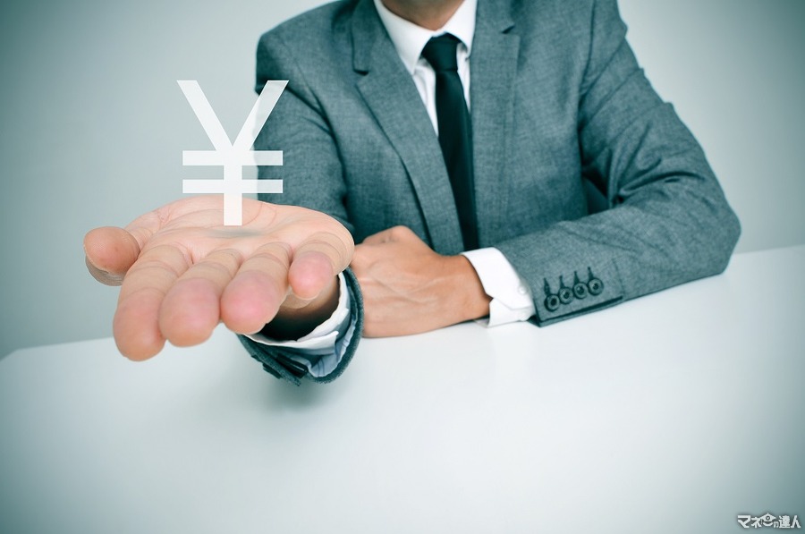 <p>a businessman sitting in a desk showing a chinese yuan or japanese yen sign in his hand</p>