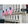<p>Wall street sign in New York with New York Stock Exchange background</p>